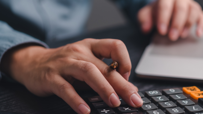 a guy manually computing payroll