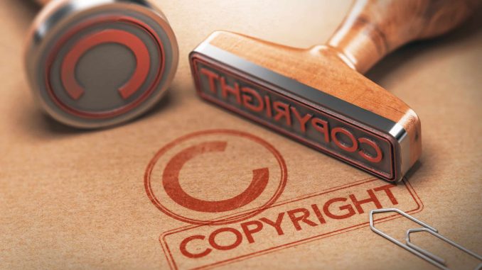 3D illustration of two rubber stamps with copyright word and symbol over kraft paper background, Concept of copyrighted material